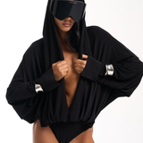 Siren ski goggles worn with a black wrap top