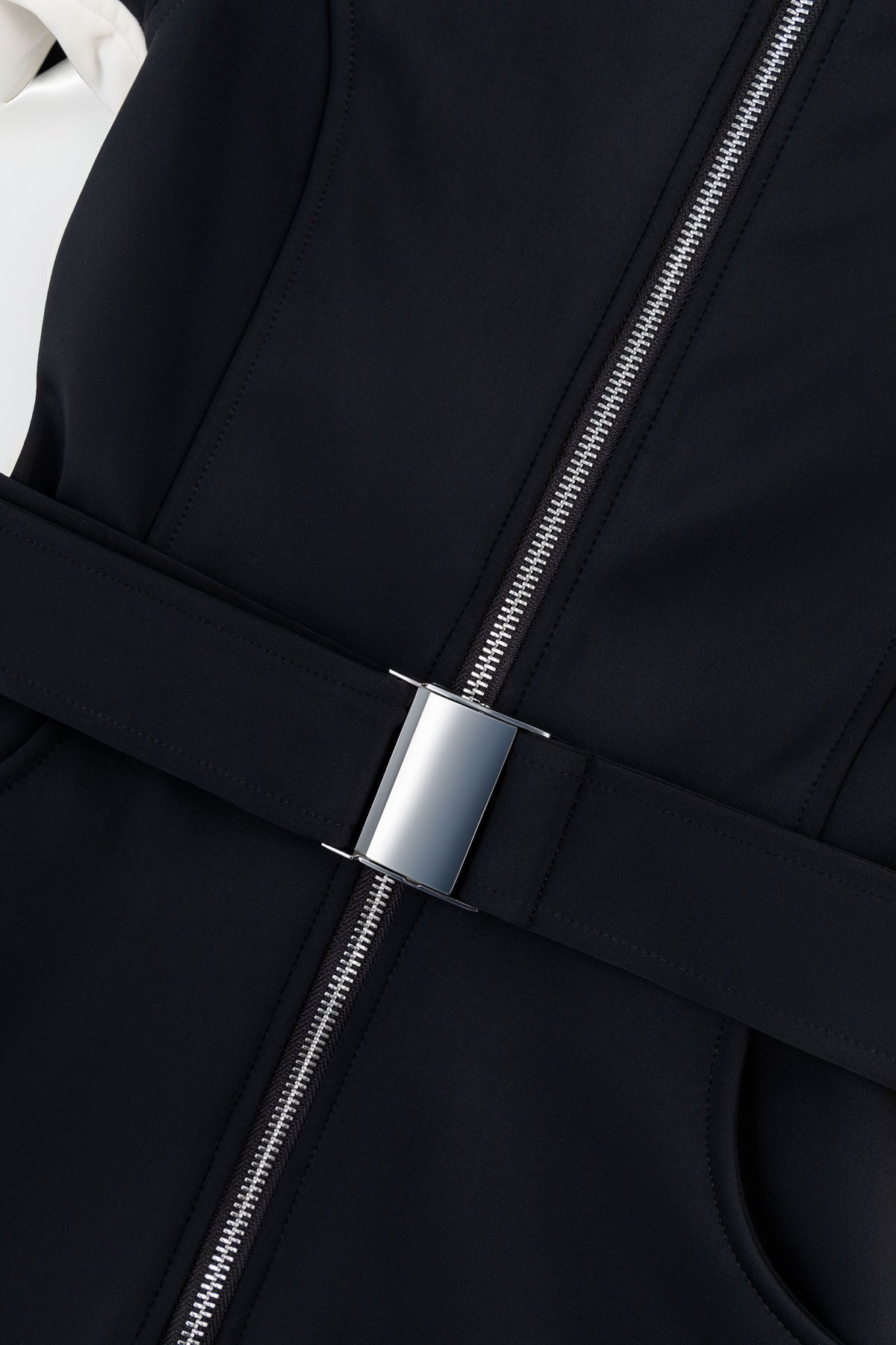Silver belt buckle and YKK zipper on the black Siren ski suit